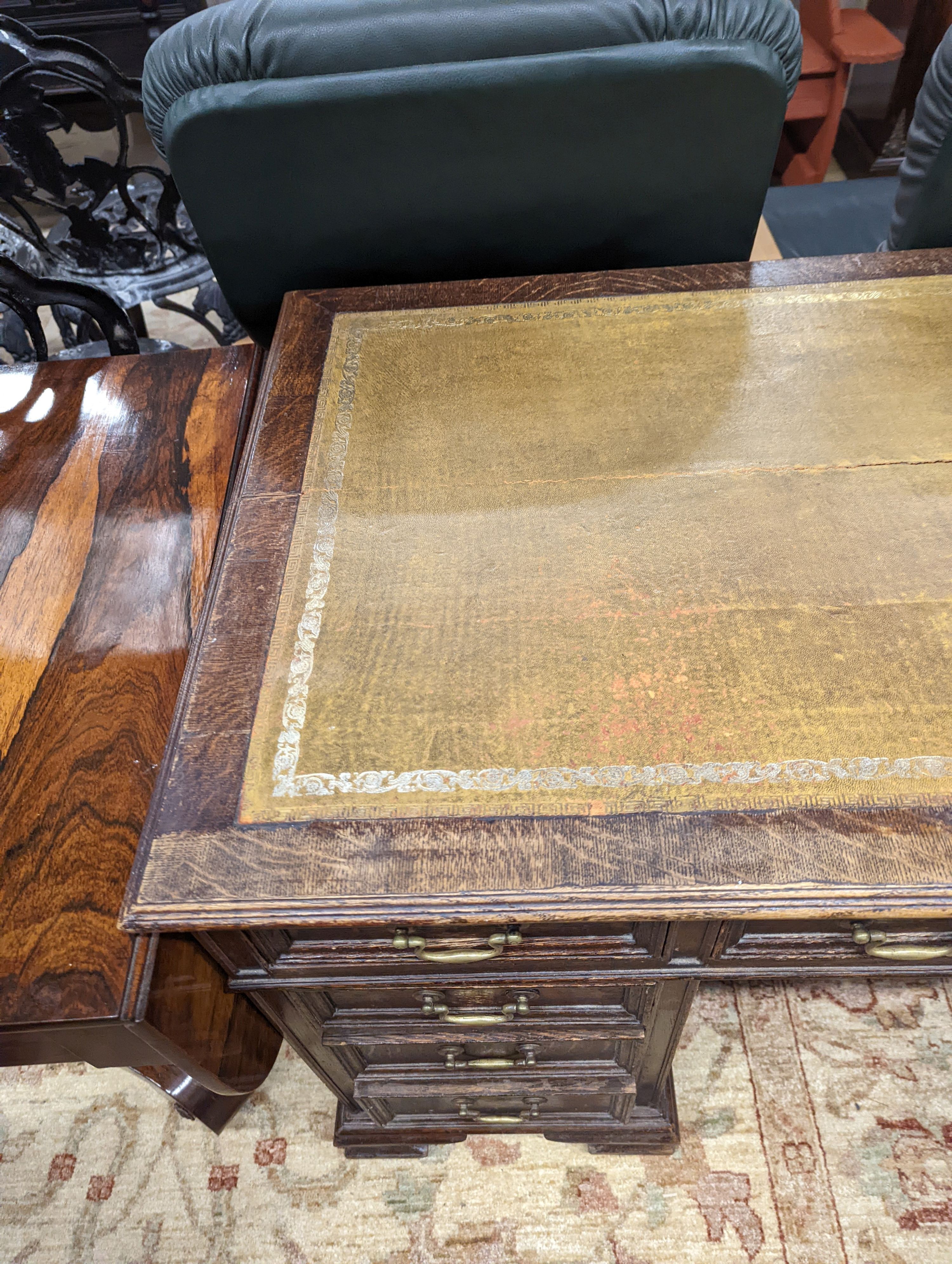 An early 20th century oak kneehole desk, length 122cm, depth 66cm, height 75cm